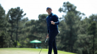 Defending champ McIlroy shares Masters lead after back-nine birdie run