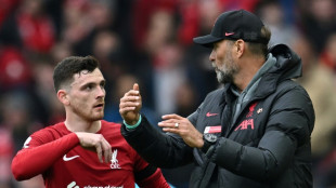 Liverpool's Robertson elbowed by assistant referee